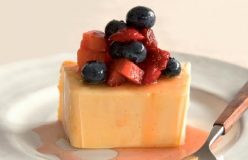 Red fruit salad with homemade vanilla ice cream and honey syrup